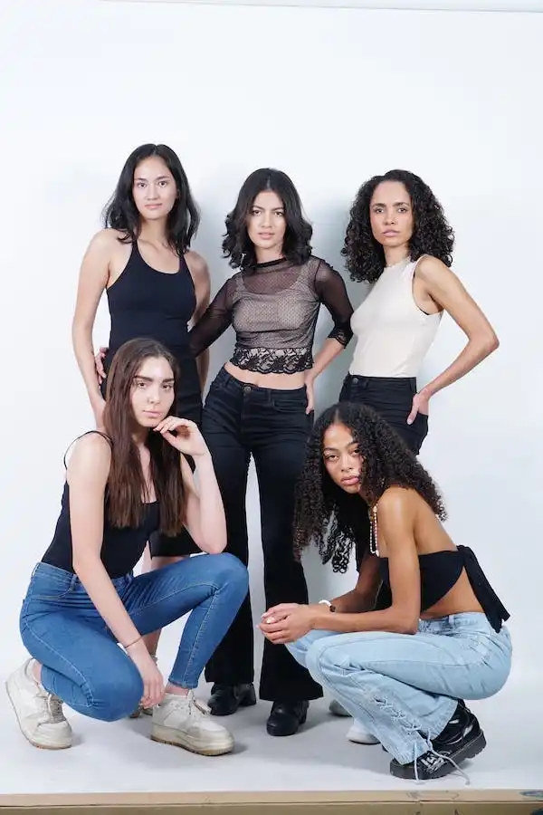5 girls standing wearing garments